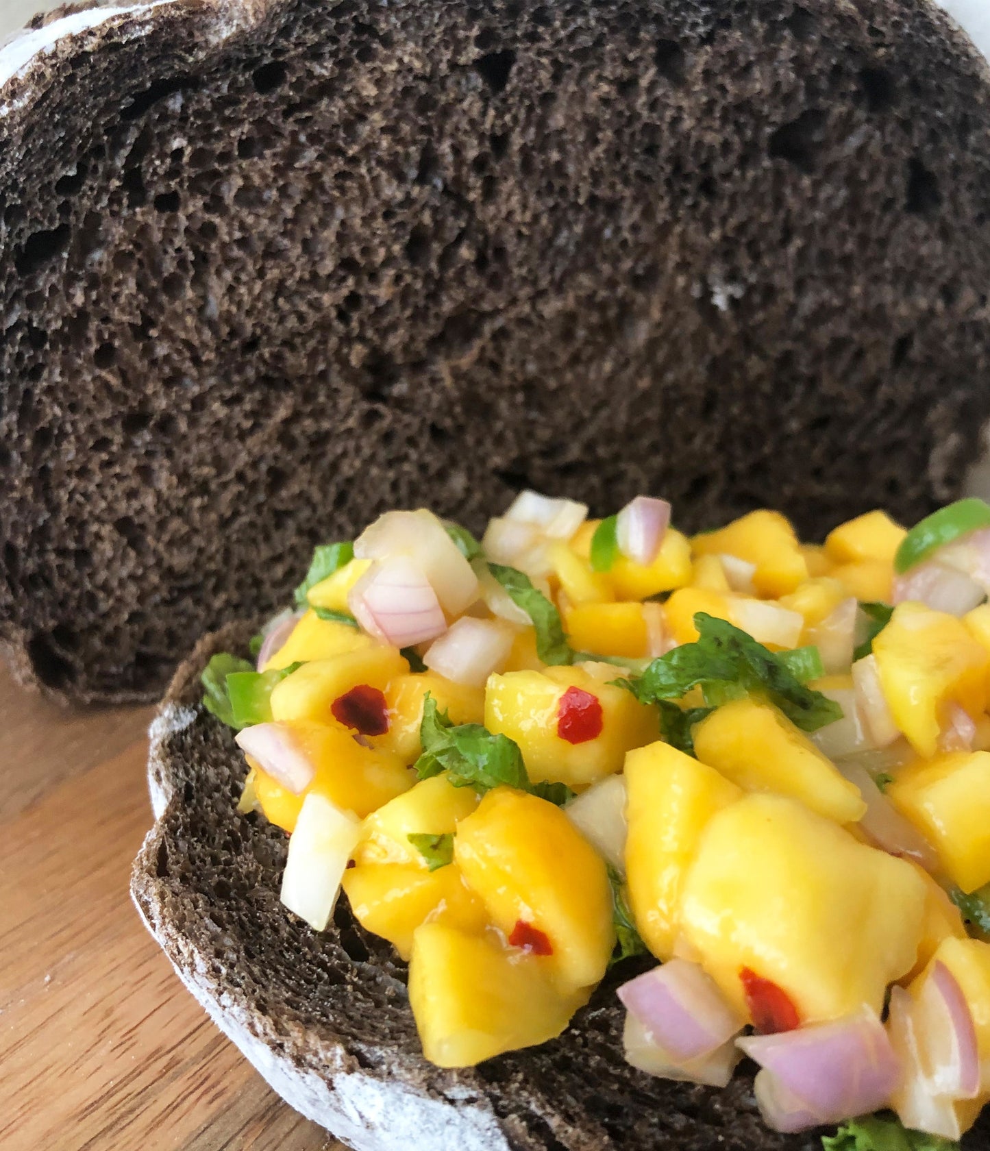 Shown here is an open toast made with our Cafe Mocha boule, topped with a sweet and spicy mango relish